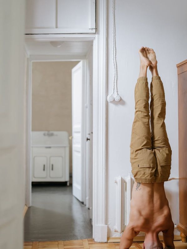 Man focusing during a workout in a spacious, well-lit room.