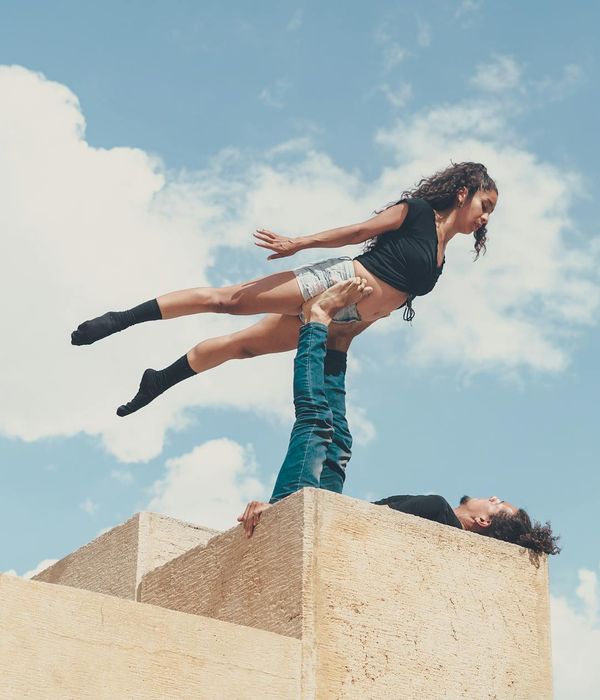 Man performing a controlled strength exercise in a minimalist environment.